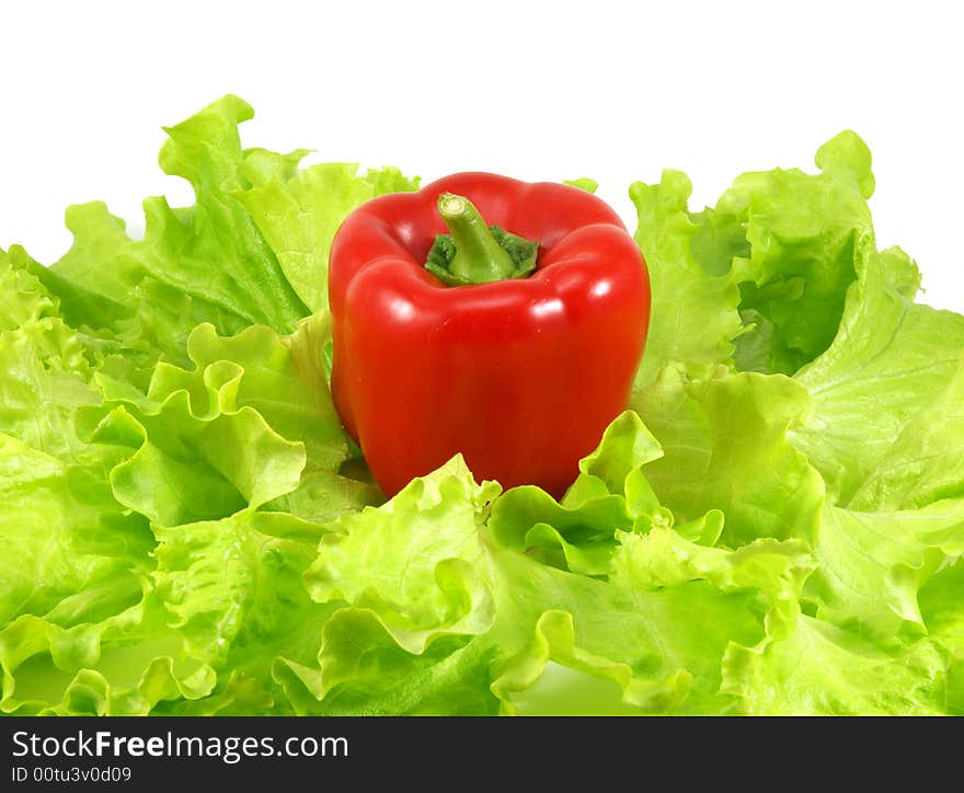 Red pepper and leaves of salad isolated on a white background