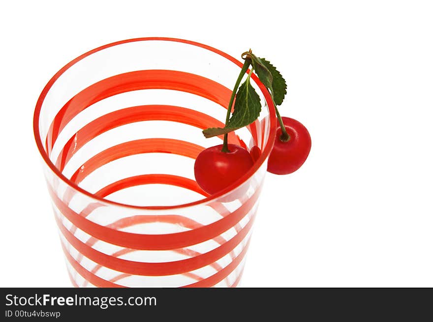 Glass with two cherries on a white background