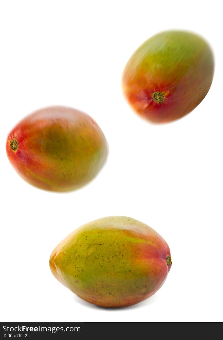 Falling mango group isolated over white. motion blur. Falling mango group isolated over white. motion blur