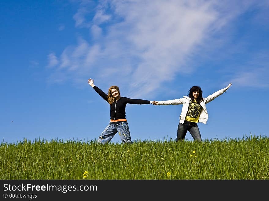 Two arms raised friends in a green meadow