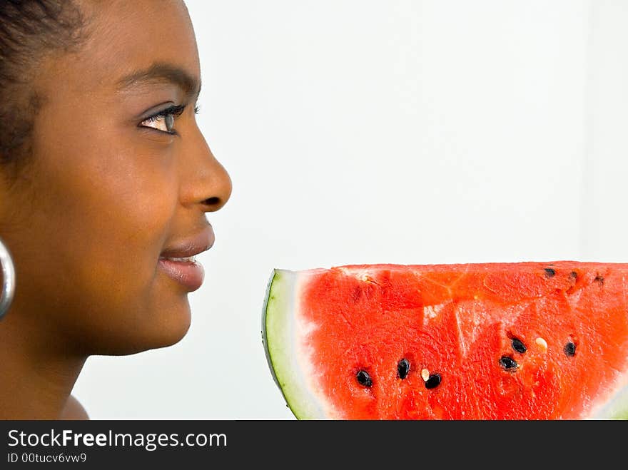 Sweet smiling girl with a red juicy wate-melon