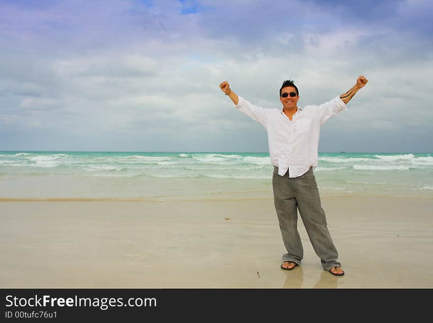 Man On Beach With Arms Extended