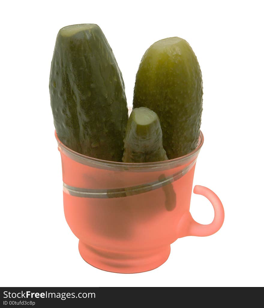 Glass mug with cucumbers on a white background. Photo.