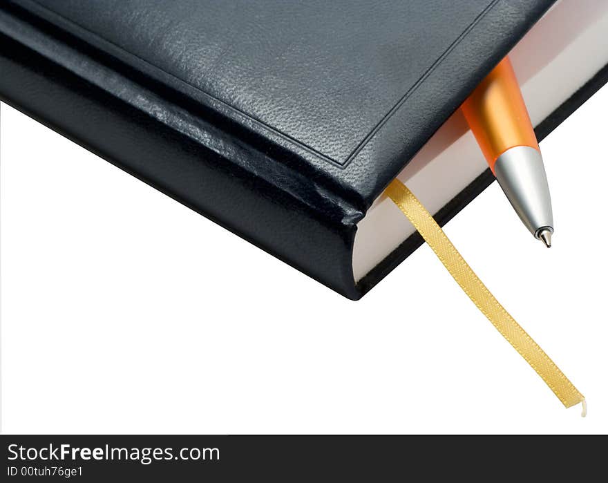 The note book with a pen on a white background. Photo.