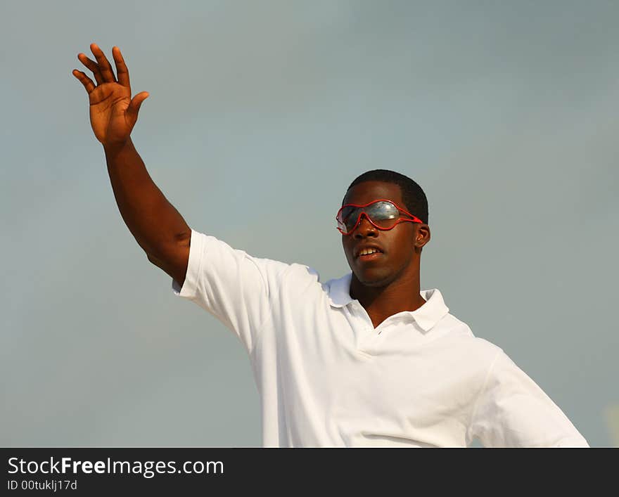 Black man waiving at the crowd