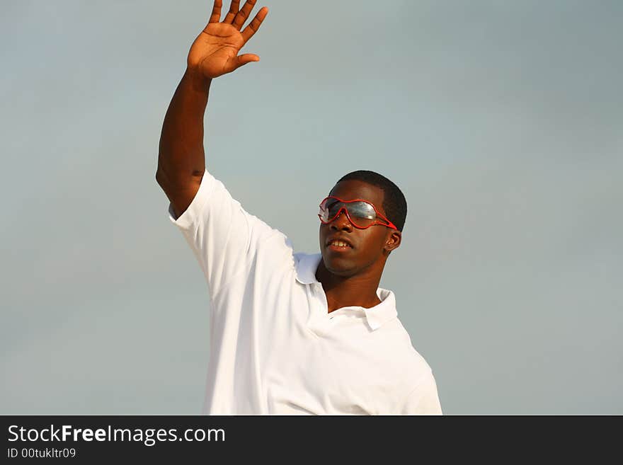 Black man waiving at a friend approaching