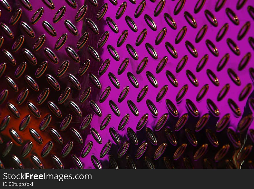 Textured perforated metallic background shot