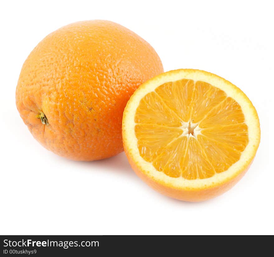 Big oranges isolated on white background one of which is cut