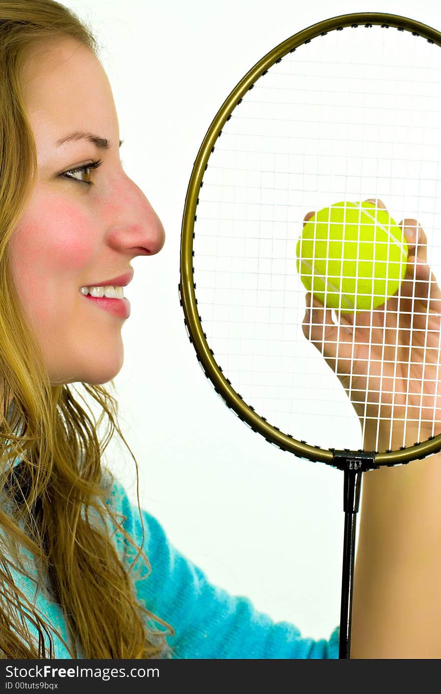 Young woman with racket and yellow ball