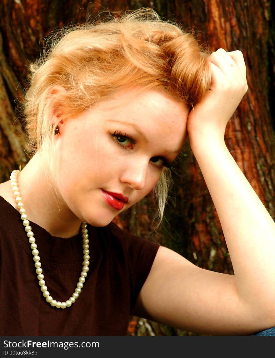 Closeup of Young Woman by Cedar Trees