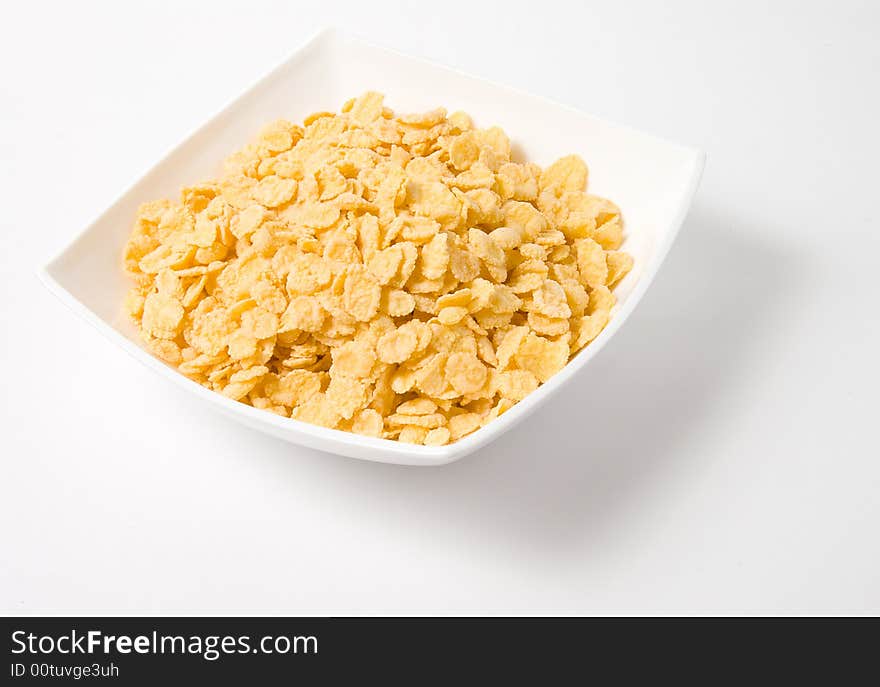 Bowl of flakes on white