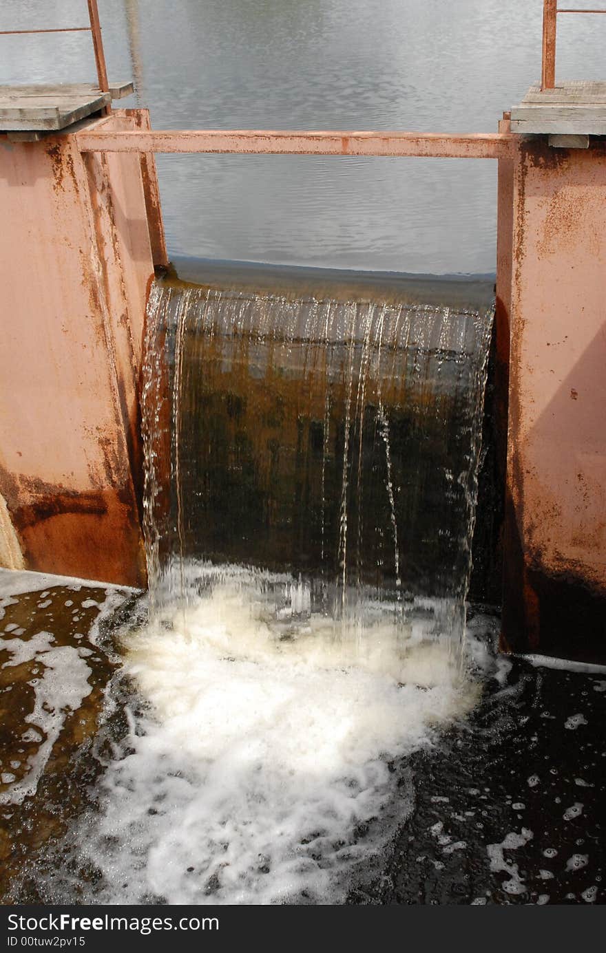 Drain of water through a dam