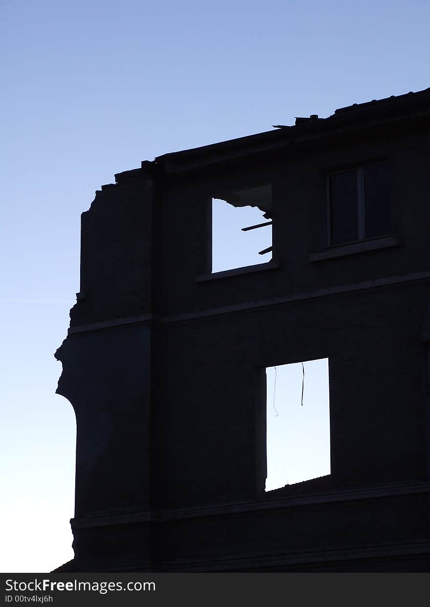 Single wall of a demolished house at dawn. Single wall of a demolished house at dawn