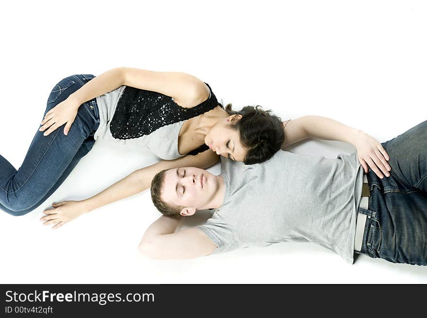 A young couple in love lying down together in a studio