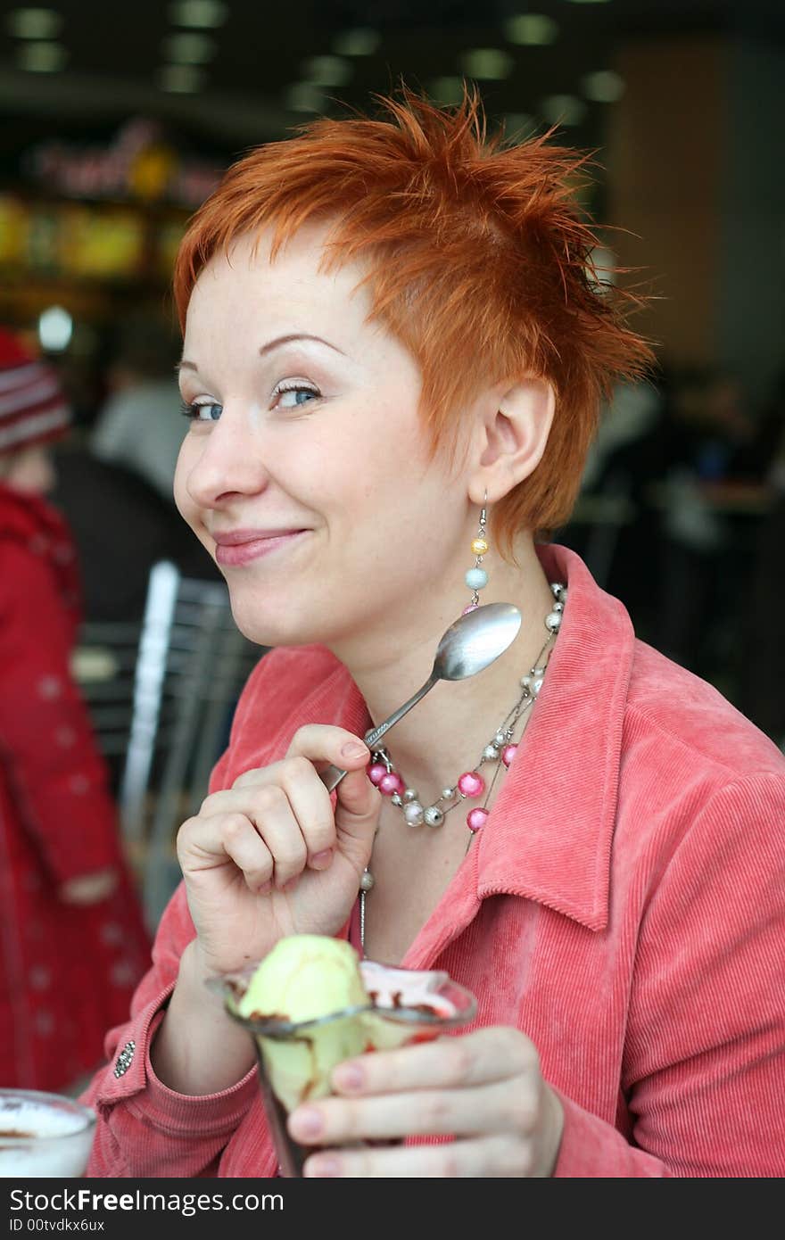 Woman eating ice cream in cafe