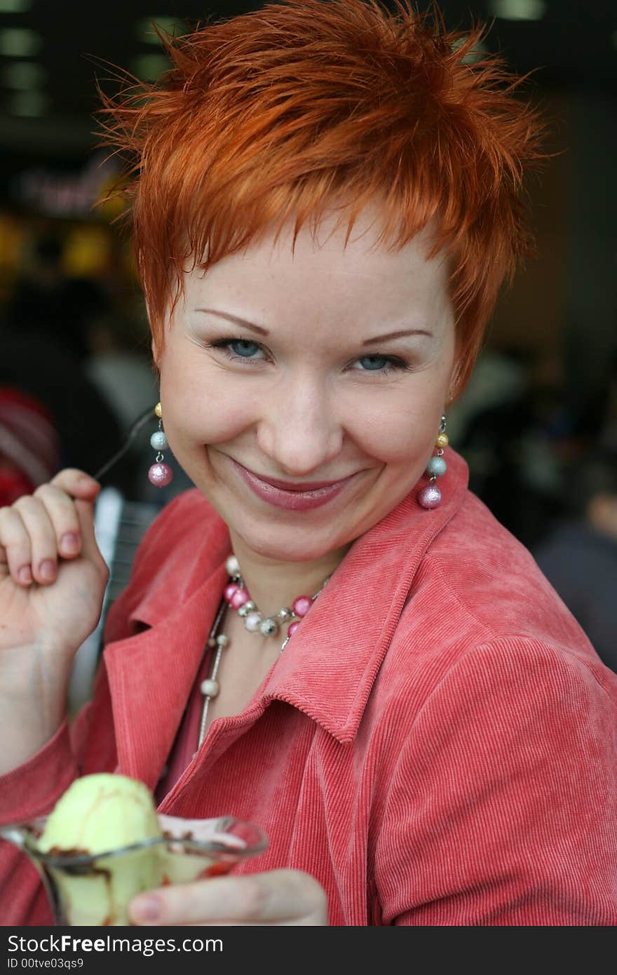 Woman eating ice cream in cafe