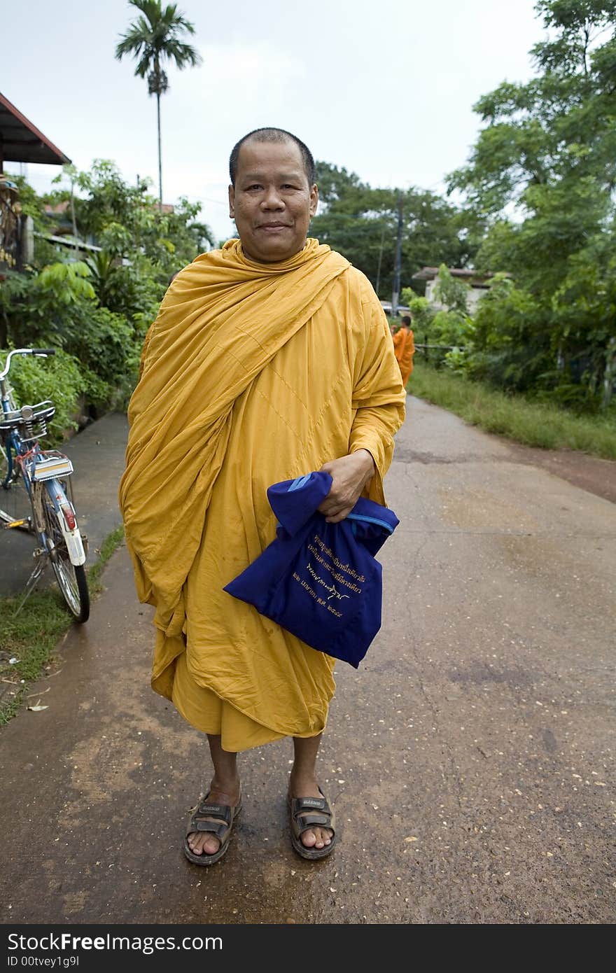 Buddhist monk from Thailand in traditional orange garb