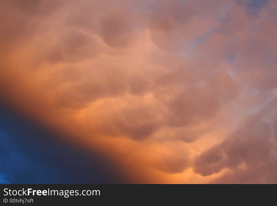 Rain cloud on late afternoon sky on sunset