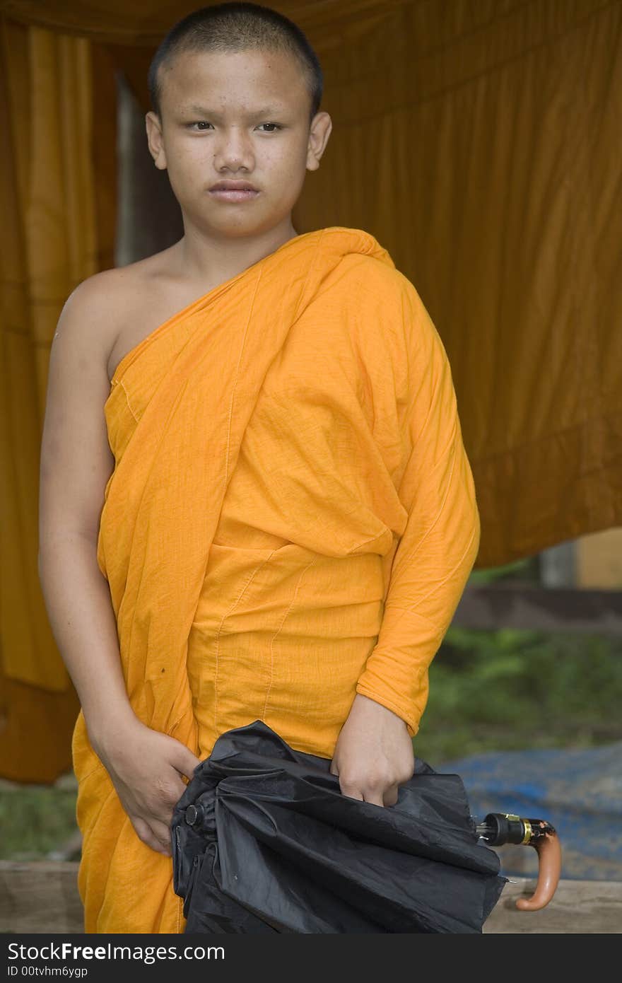 Buddhist monk from Thailand in traditional orange garb