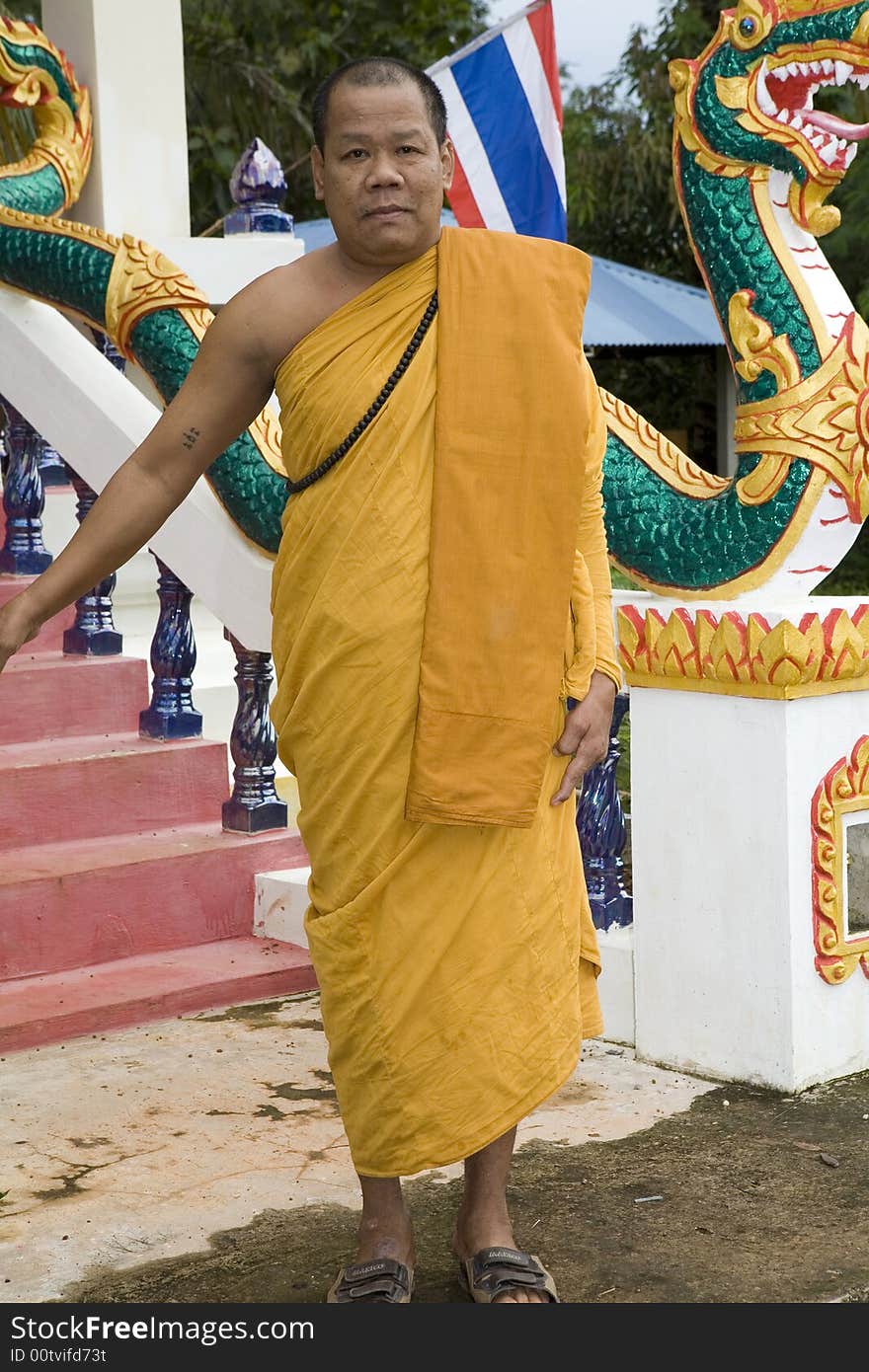 Buddhist monk from Thailand in traditional orange garb