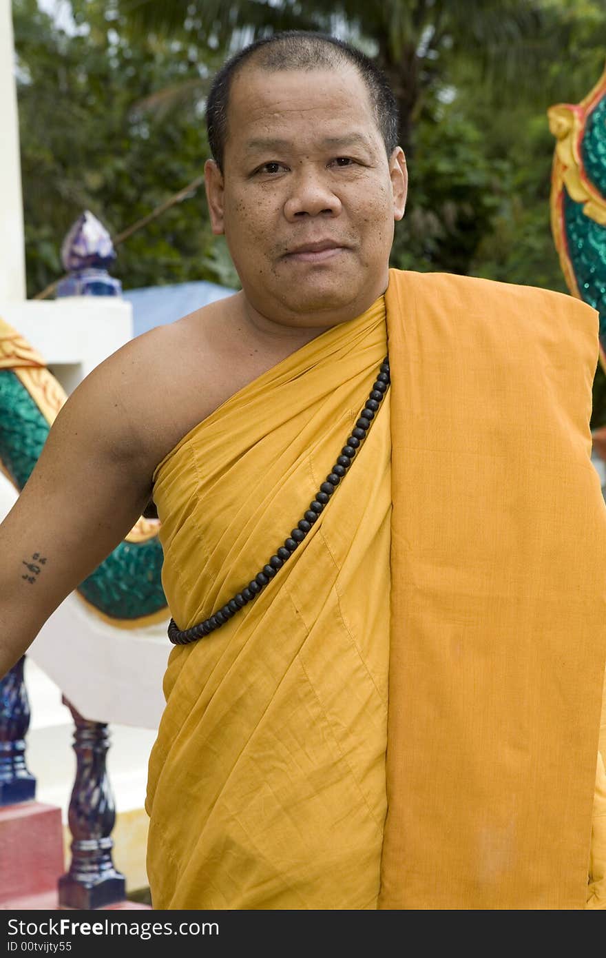 Buddhist monk from Thailand in traditional orange garb