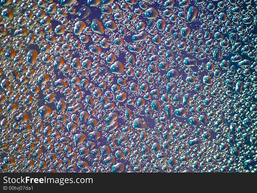 Water drops on the violet background. Blur on the edges of the frame � lens feature.