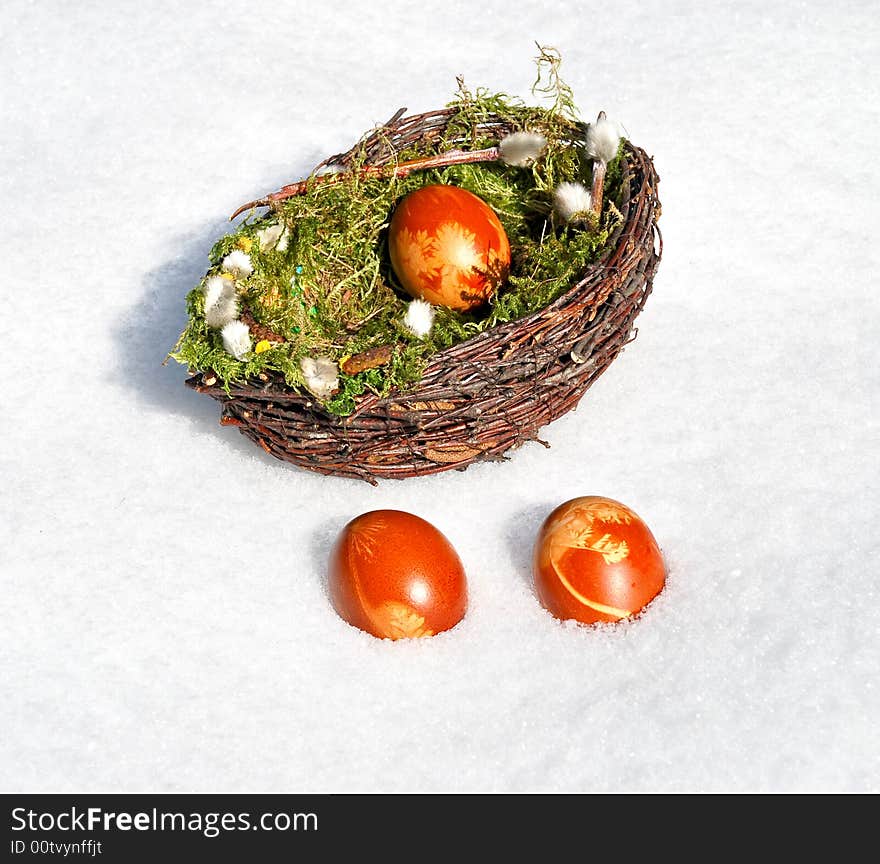 White snow and Easter Eggs in the basket. White snow and Easter Eggs in the basket