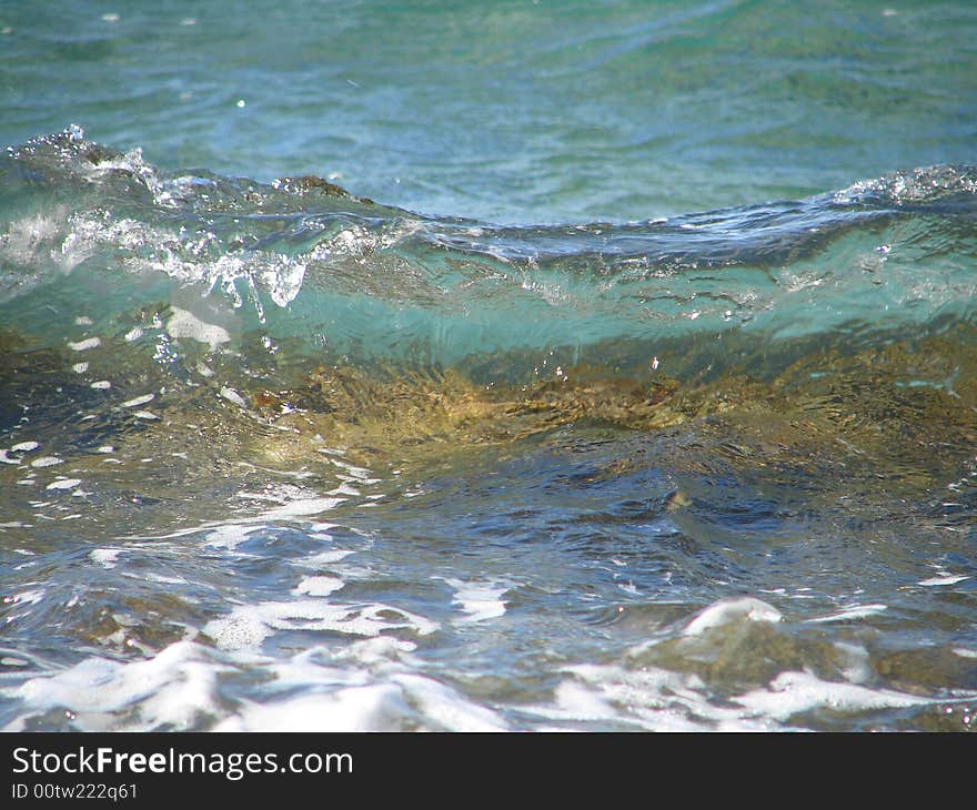 Small wave on crystal clear water