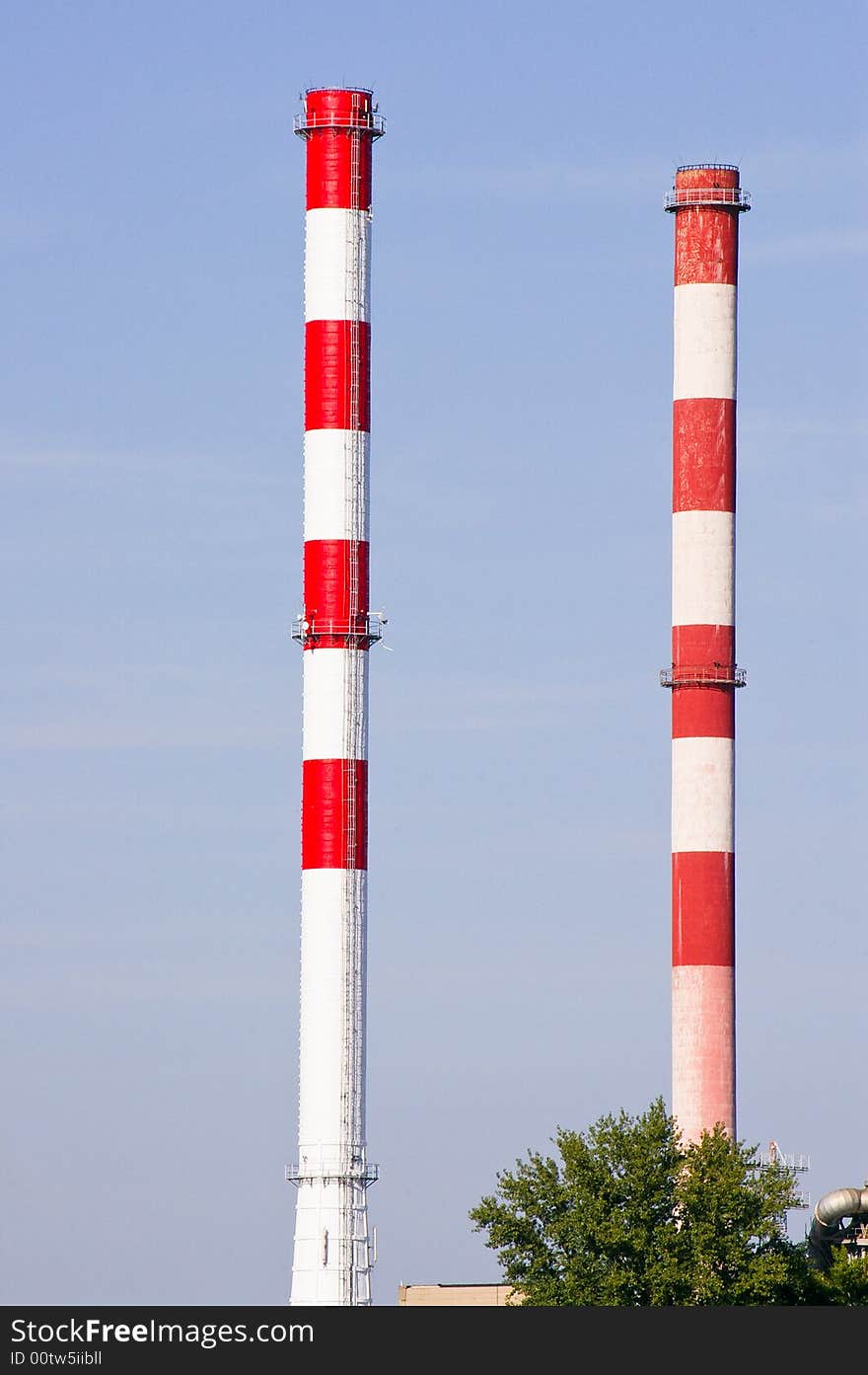 Tall two colored industrial chimneys