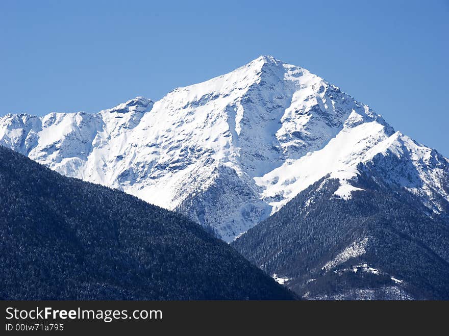 A close up of Legnone mountain after a snowfall - in blue light. A close up of Legnone mountain after a snowfall - in blue light