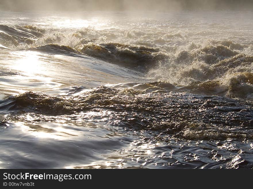 August foggy morning: river, foam; splashes