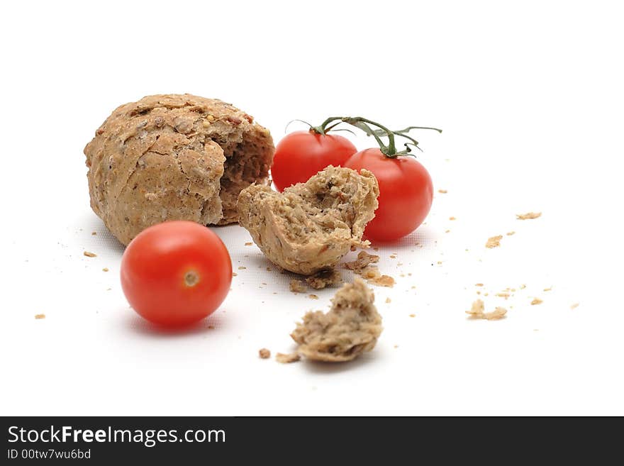 Red tomato and a lot of crumbs of bread. Red tomato and a lot of crumbs of bread