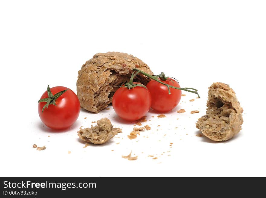 Red tomato and a lot of crumbs of bread. Red tomato and a lot of crumbs of bread