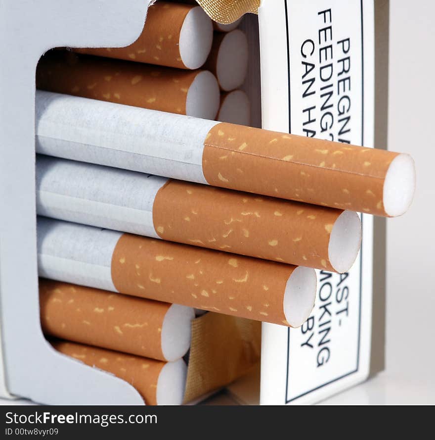 Cigarettes being offered from a packet.  A macro image. Cigarettes being offered from a packet.  A macro image.