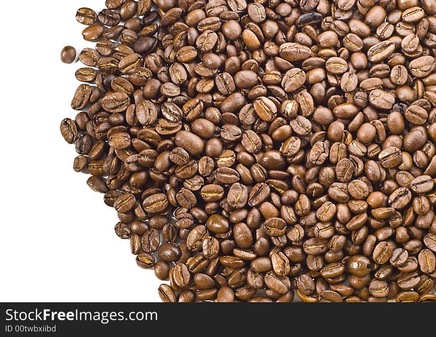 Pile of coffee beans spilled over white background. Pile of coffee beans spilled over white background