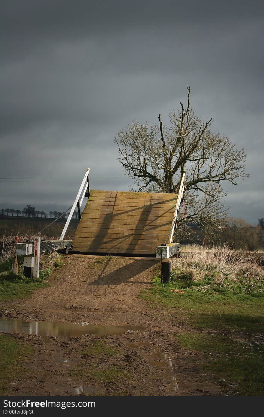 A wooden bridge over a canal in a Oxfordshire field. A wooden bridge over a canal in a Oxfordshire field