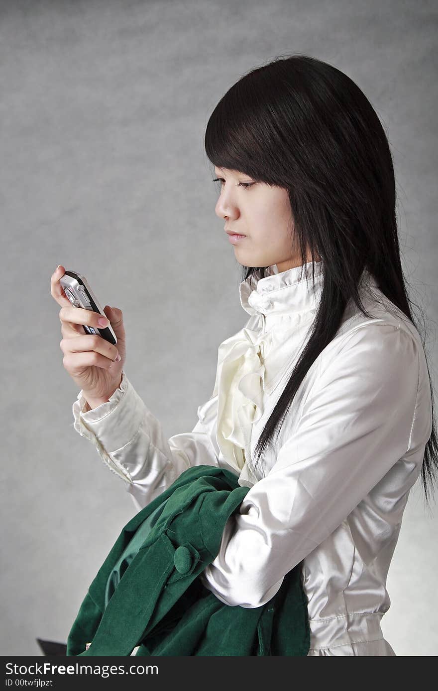 China's white-collar class image...She is looking over the information in the mobile phone. China's white-collar class image...She is looking over the information in the mobile phone.