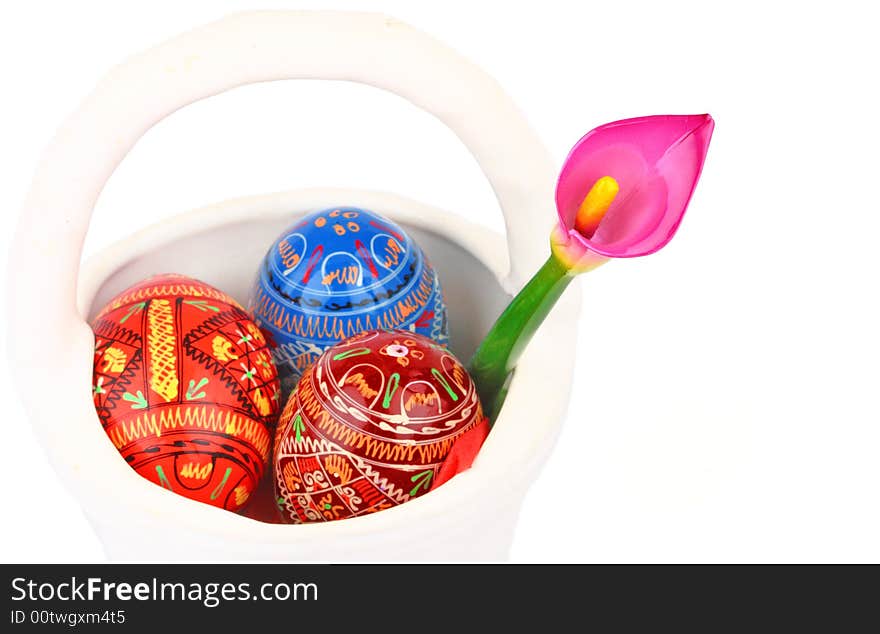 Three russian tradition easter eggs and violet orchid in white porcelain basket. Three russian tradition easter eggs and violet orchid in white porcelain basket