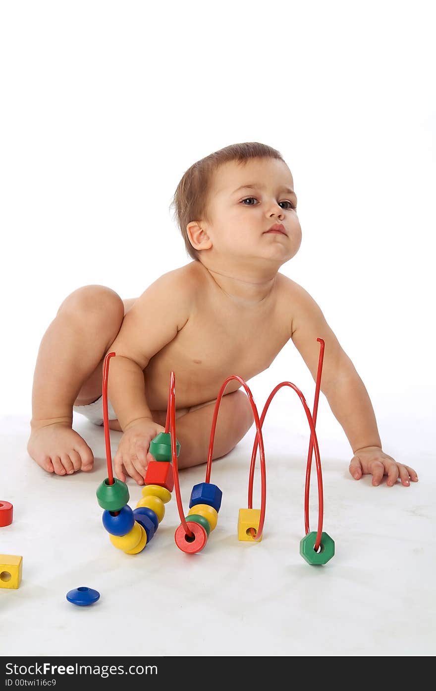 Boy sitting near multicolored cubes and curl isolated on white