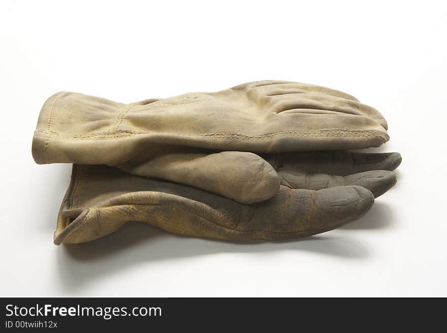 Image of a pair of right gloves without the left glove.  These are calf skin work gloves used for gardening and other outside labor.  Ine glove is on top of the other palm facing each other.  They are viewed from the side. Image of a pair of right gloves without the left glove.  These are calf skin work gloves used for gardening and other outside labor.  Ine glove is on top of the other palm facing each other.  They are viewed from the side.