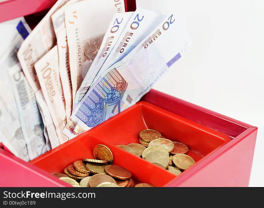 Red cash-box filled with Euro notes and coins