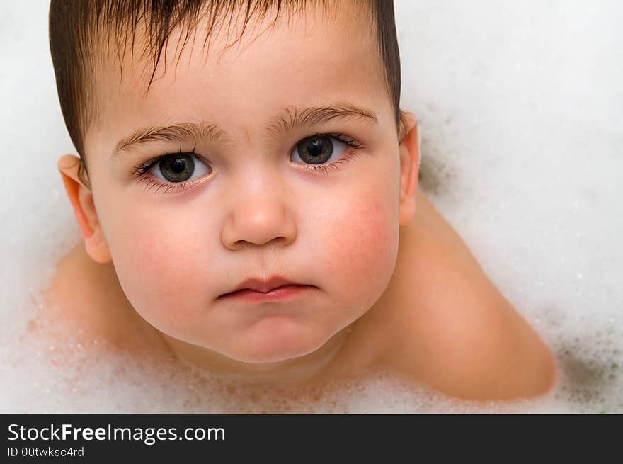 Close-up photo of serious boy in foam