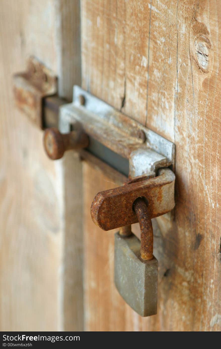 Rusty lock on the wooden door. Rusty lock on the wooden door