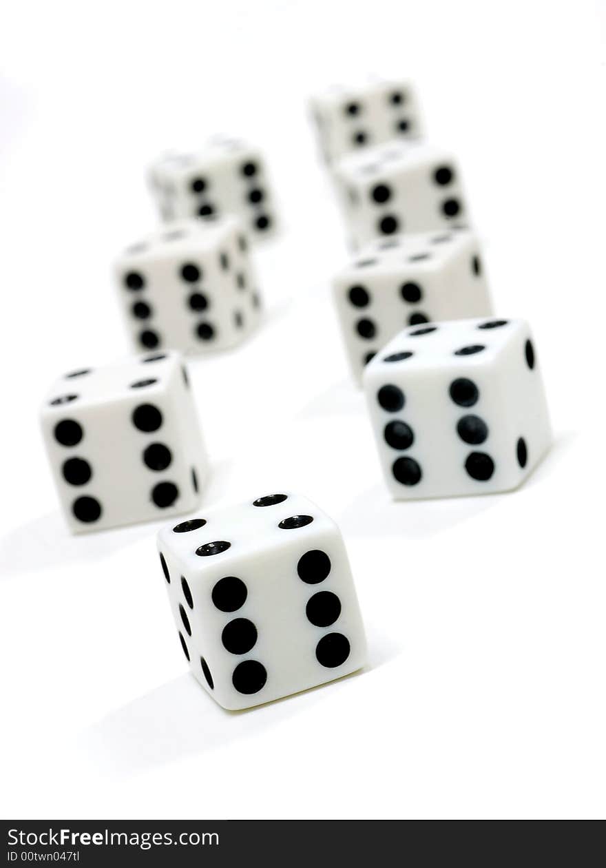 Dice lined up on a white background. Shallow depth of field. Dice lined up on a white background. Shallow depth of field