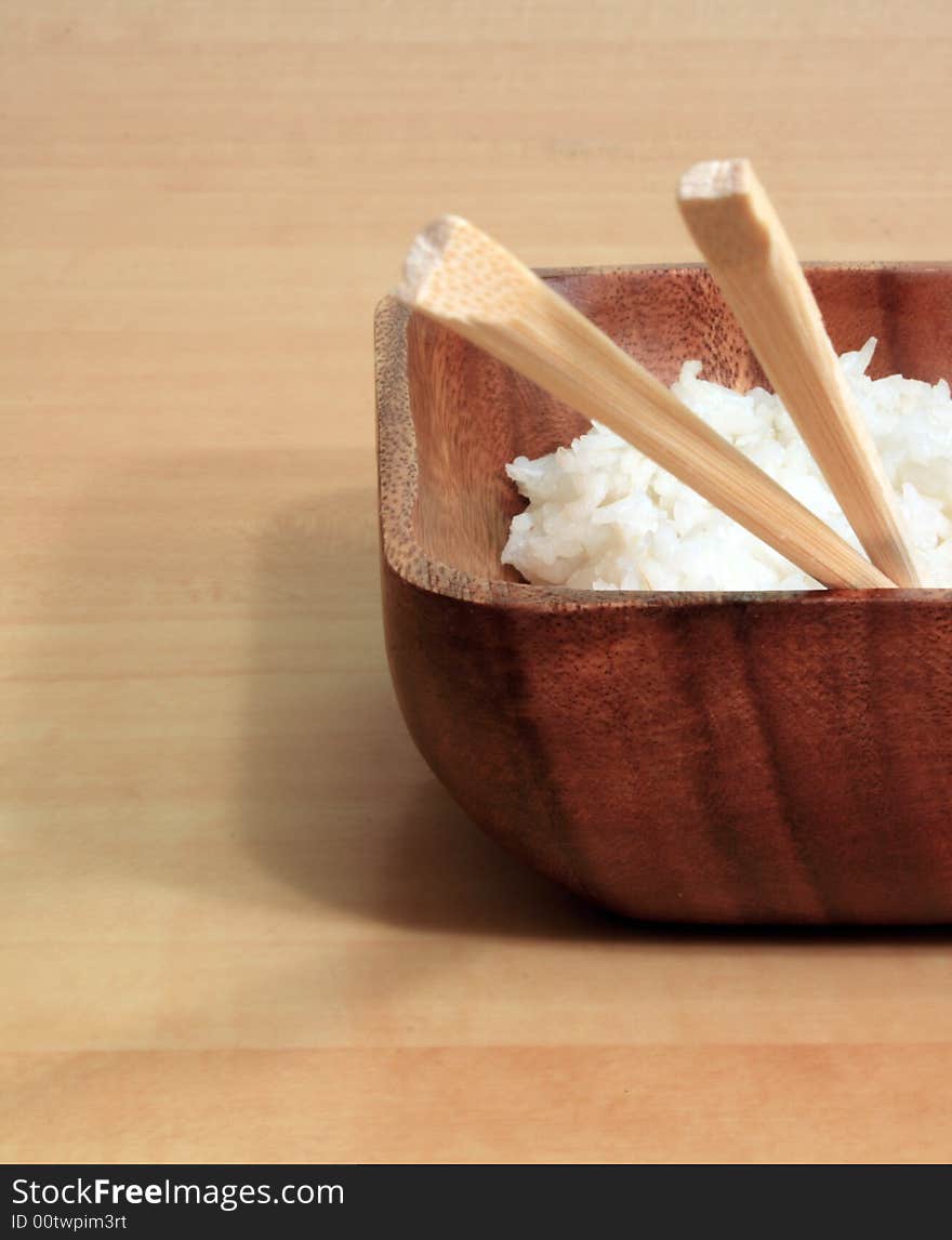 Bowl of rice with wooden chopsticks. Bowl of rice with wooden chopsticks.