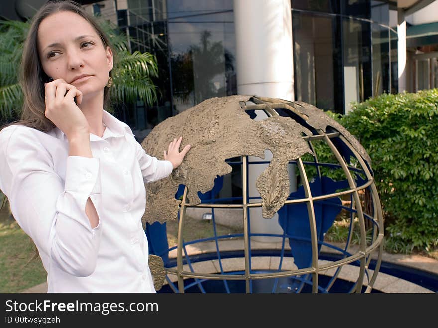 Woman in business attire on her cell phone outdoors. Woman in business attire on her cell phone outdoors