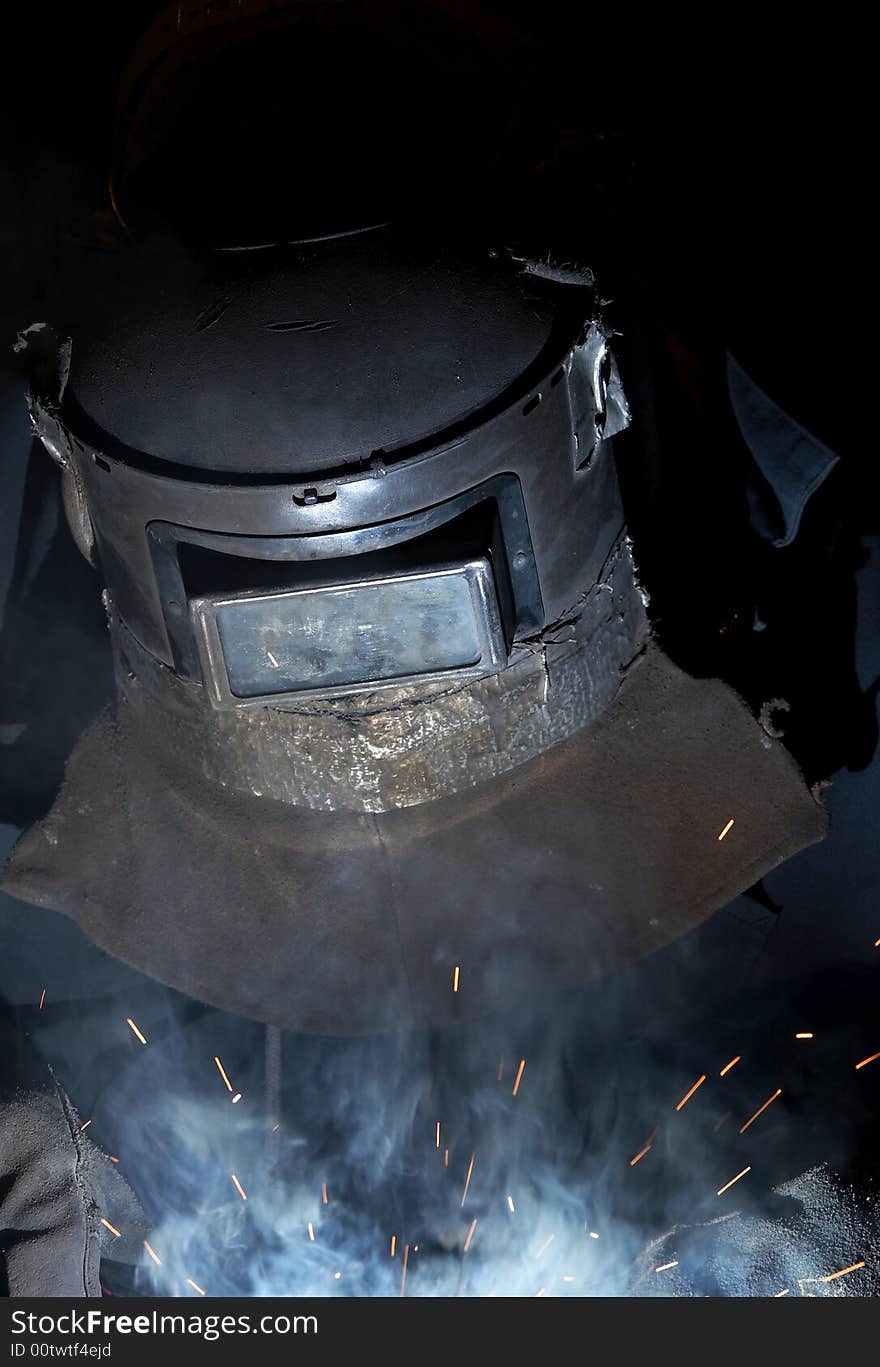 A welder working at shipyard at night. A welder working at shipyard at night