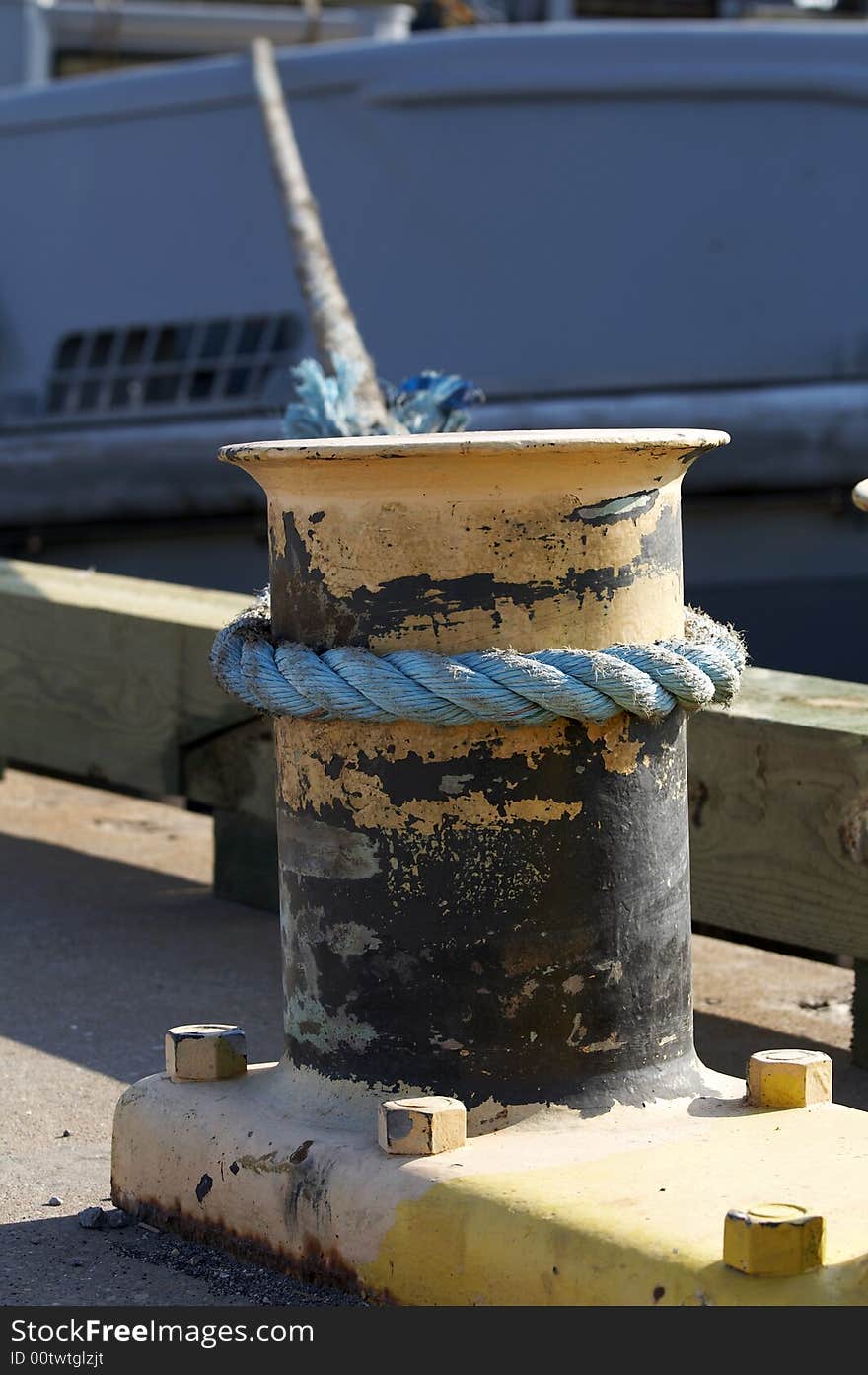 A rope on bit holding ship to dock. A rope on bit holding ship to dock