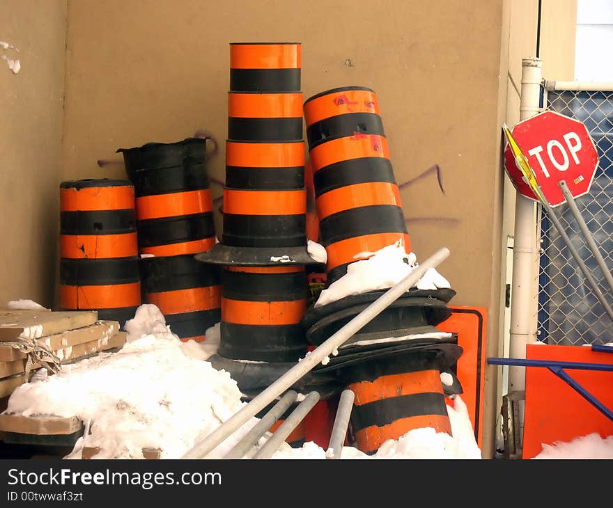 Shot of orange and black construction traffic barrels.