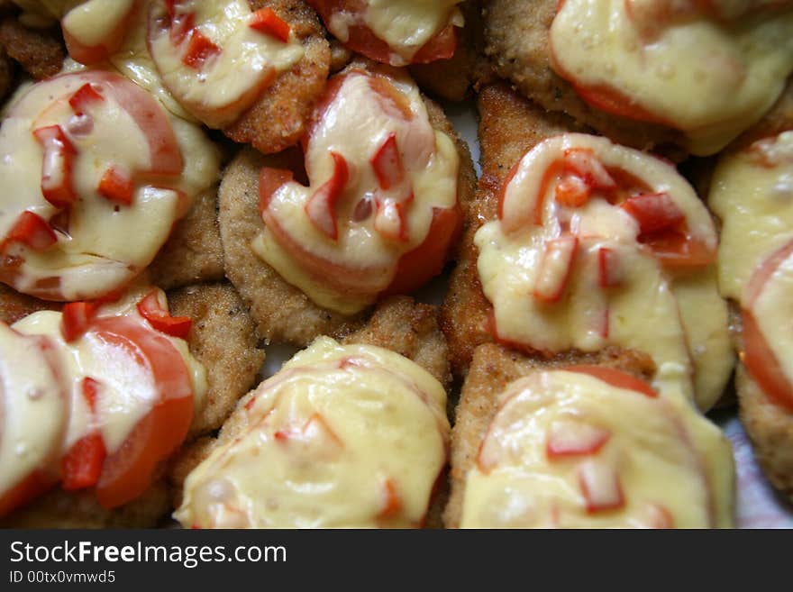 Pork chops with cheese, tomato and red pepper, food background